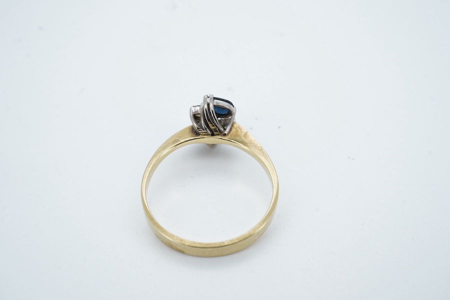 An 18ct two stone pear cut sapphire and two stone diamond cluster set ring, size P/Q, gross weight 3 grams. Condition - fair